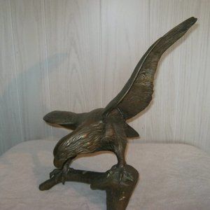 Brass Eagle sitting on a branch